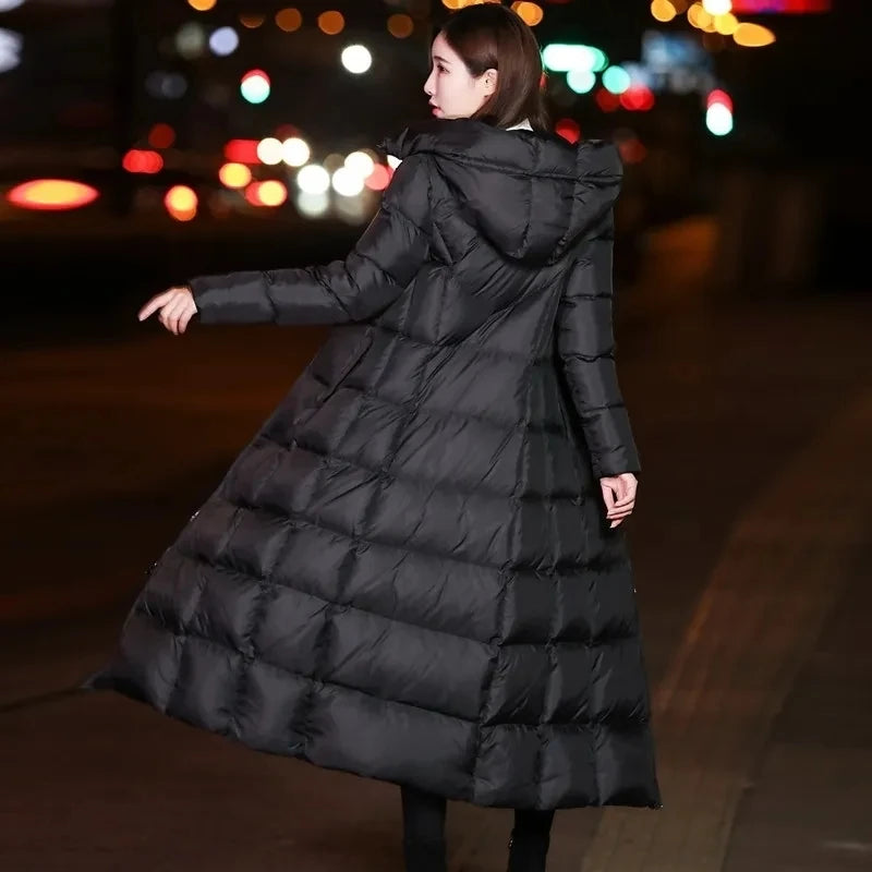 Parka d'hiver longue matelassée pour femme, arrivant au-dessus du genou.Veste matelassée épaisse à capuche pour femme